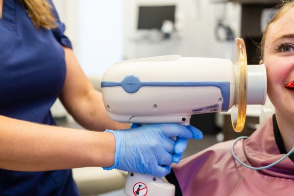 Dental Hygienist Taking an Xray of a Patient's Teeth