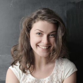 Beautiful young woman smiling about the benefits of dental implants